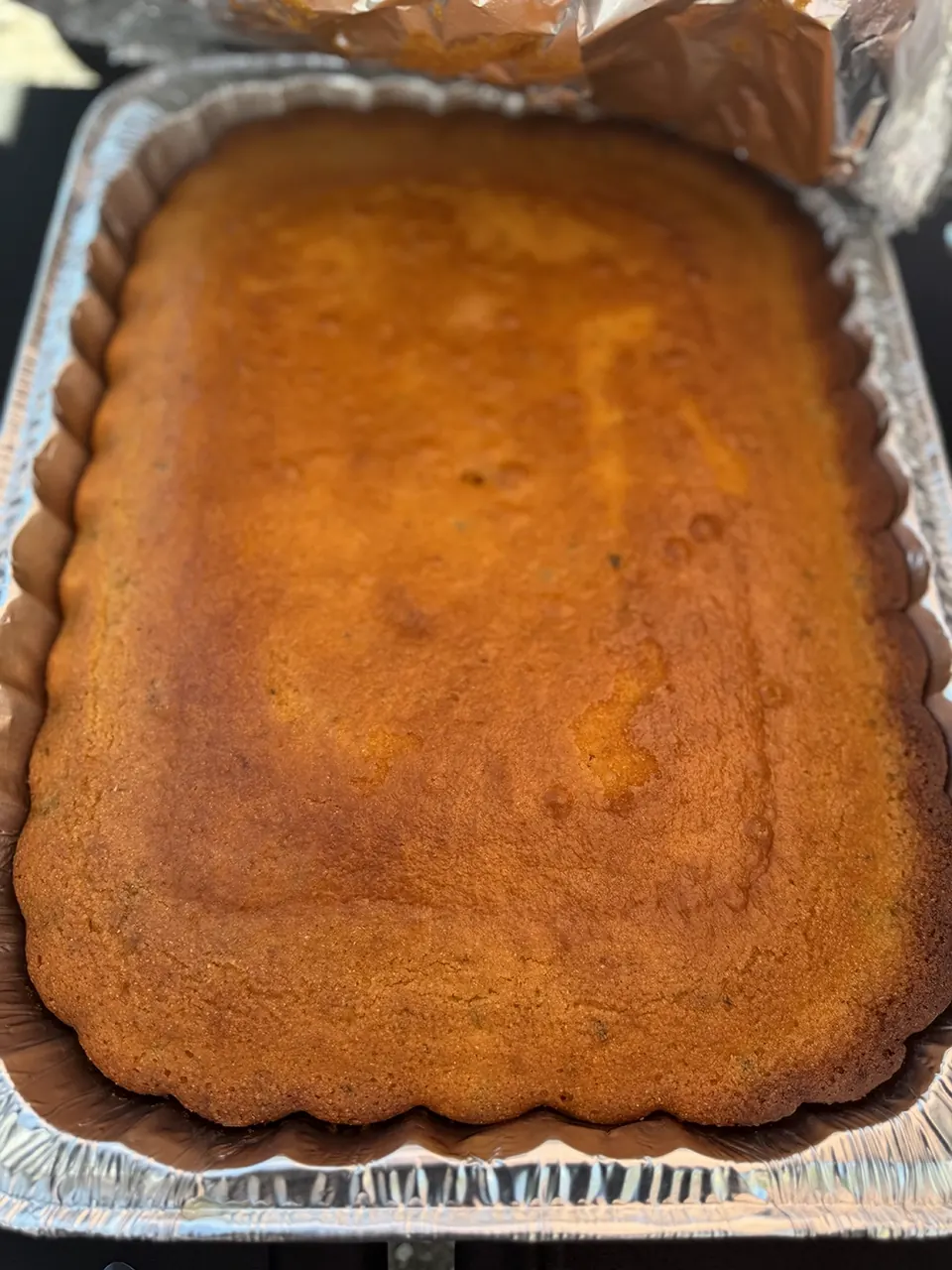 Golden cornbread baked in a rectangular foil pan