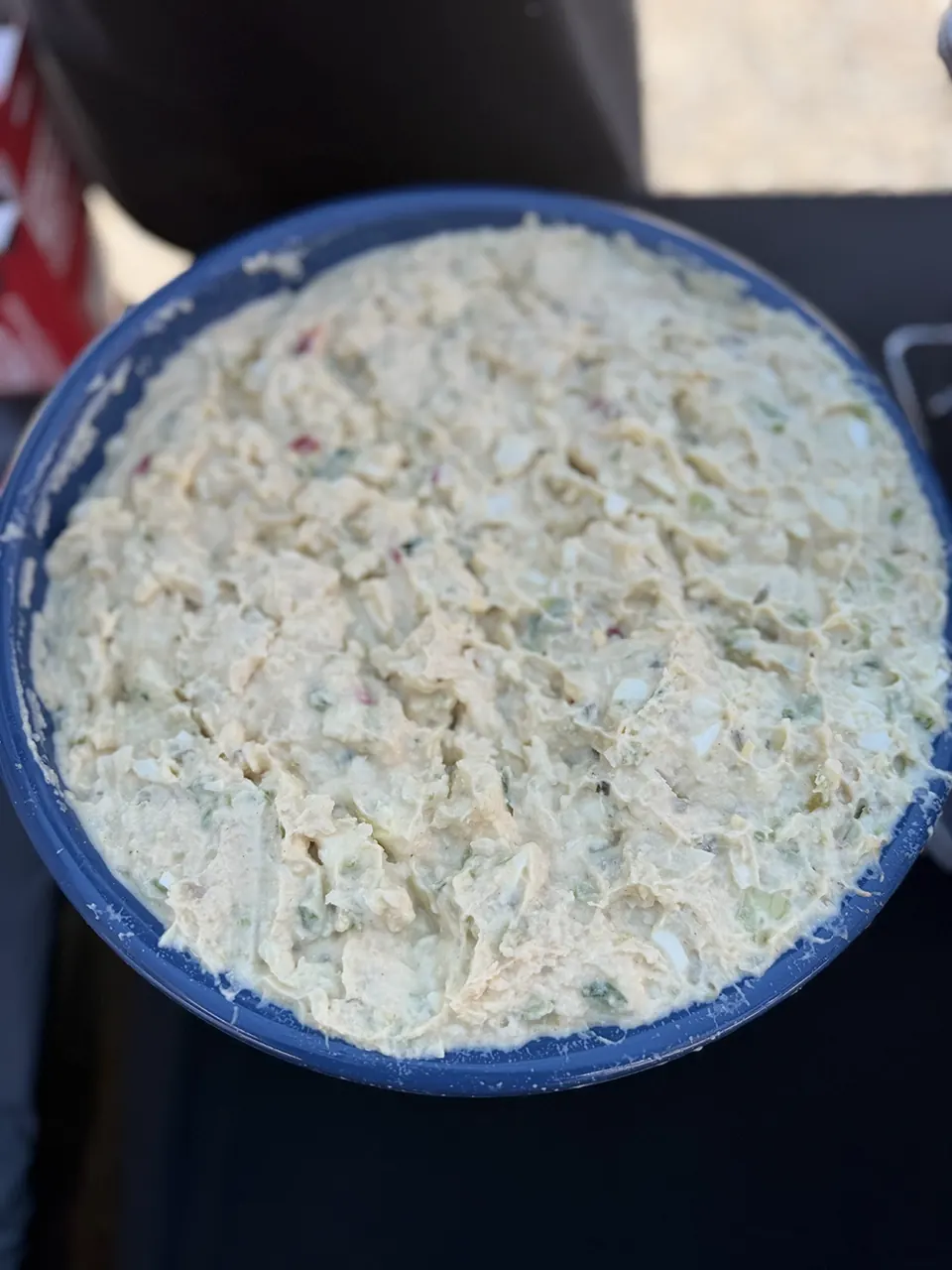 A creamy salad in a blue serving bowl