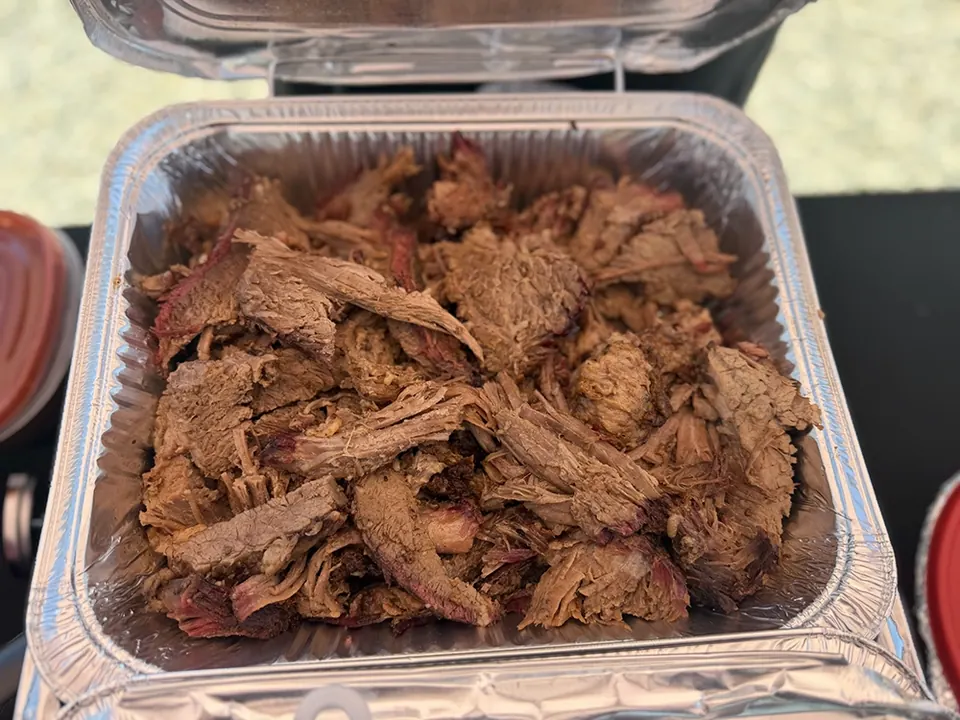 Pulled pork in a foil pan set inside a chafing dish